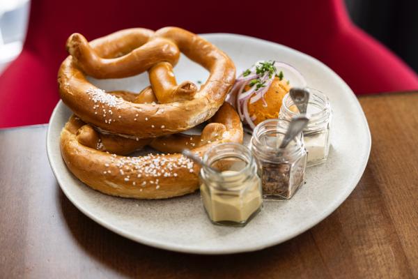 two pretzels with a trio of mustards and Bavarian bier cheese spread