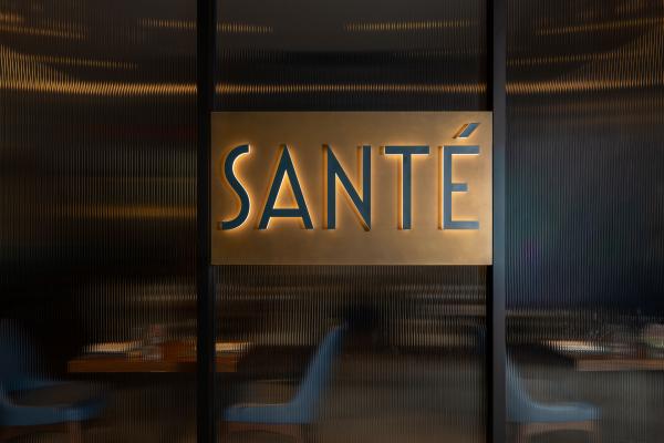 A striking view of the Santé restaurant wall, where the logo stands as a bold yet elegant focal point.