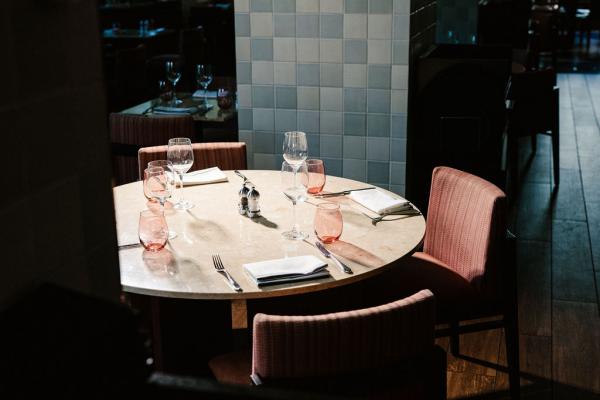 large round table set with chairs and tableware for four