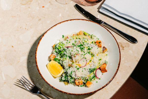 caesar salad pated on large round bowl and placed on top of a round table