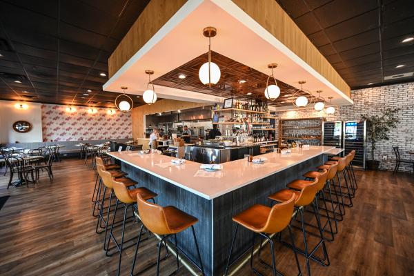The bar at Local Provisions sits as a centerpiece of the restaurant separating the dining room on either side