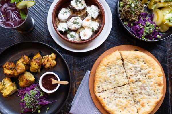 Assorted Dishes at Supra: Imeruli Khachapuri, Chicken Mtsvadi, Mushroom with Sulguni Cheese, Pickle Assorti, Cocktail