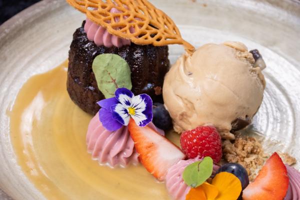 chocolate dessert with fresh fruit and edible flowers