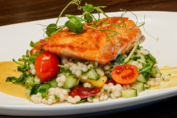 Ōra King Salmon* cucumber, baby arugula, baby tomatoes, couscous, tahini, lemon vinaigrette 