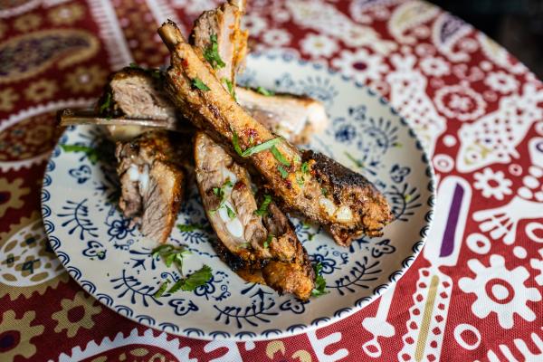 Pomegranate-Glazed Pork Ribs on a colorful traditional Georgian tablecloth